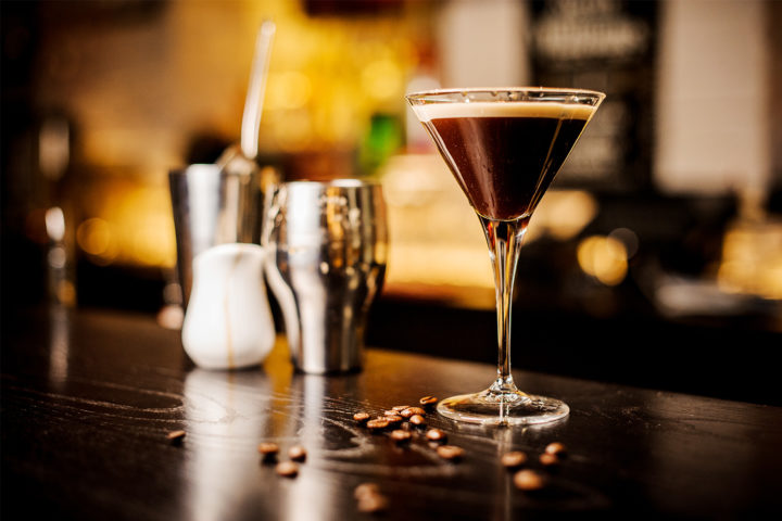 Freshly prepared espresso martini with coffee beans and vodka