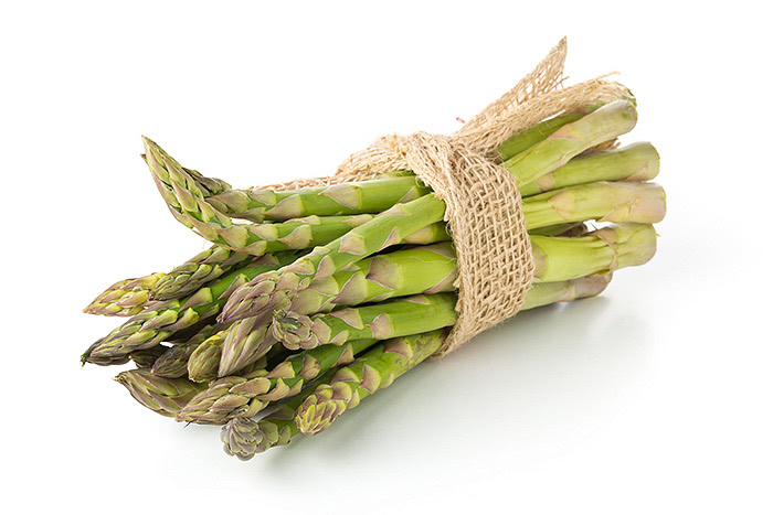 Green asparagus spears on white background