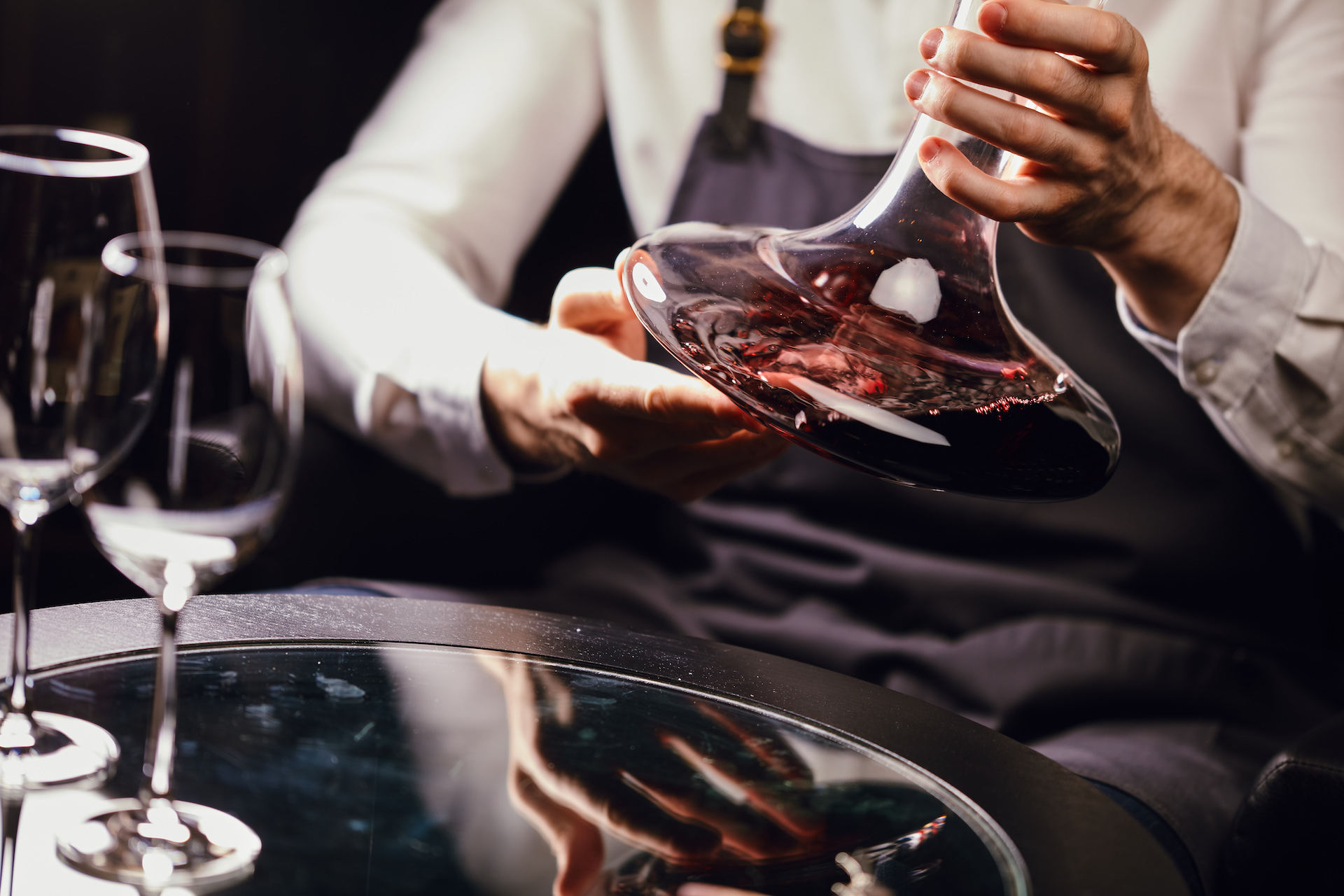 Red wine in a carafe that is swirled by a sommelier so that the wine can breathe