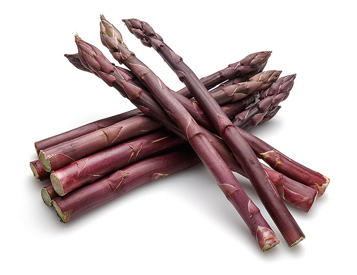 Purple asparagus spears on white background