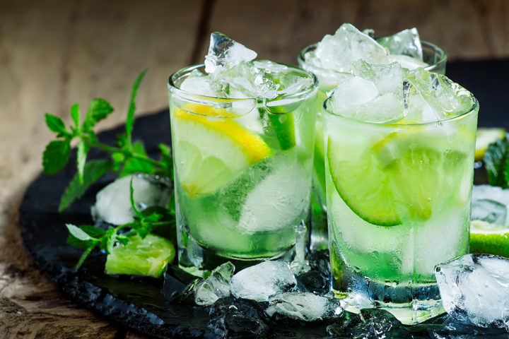 Vodka Lemon recipe garnished with limes, lemons and mint on a slate plate